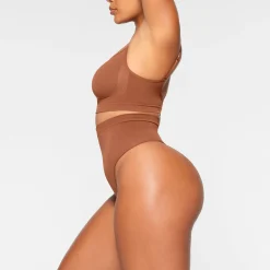 SEAMLESS SCULPT MID WAIST THONG | BRONZE