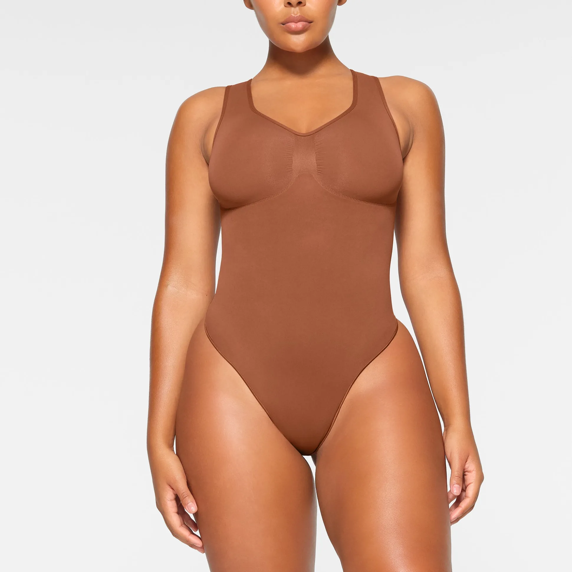 SEAMLESS SCULPT SCOOP NECK THONG BODYSUIT | BRONZE