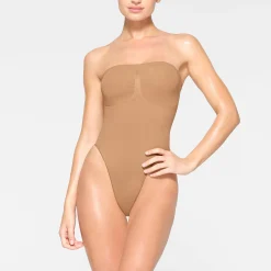 SEAMLESS SCULPT STRAPLESS THONG BODYSUIT | OCHRE